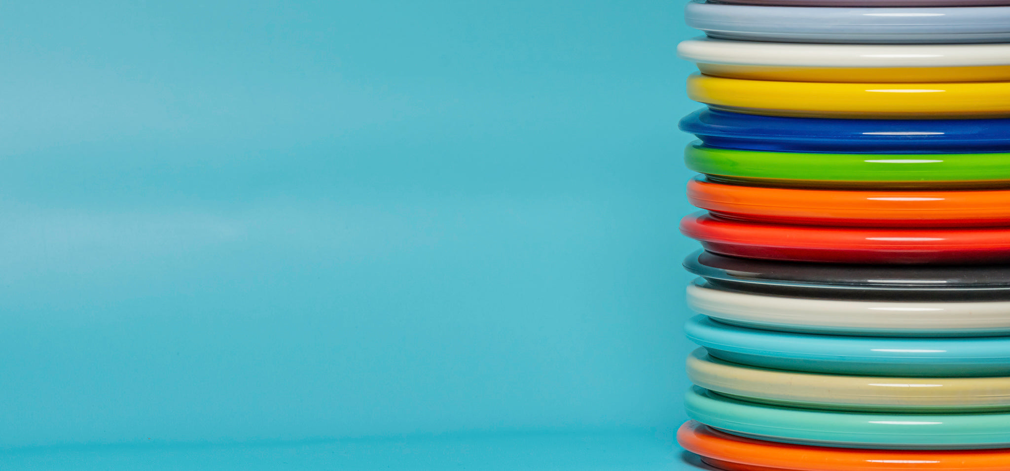 A stack of midrange disc golf discs