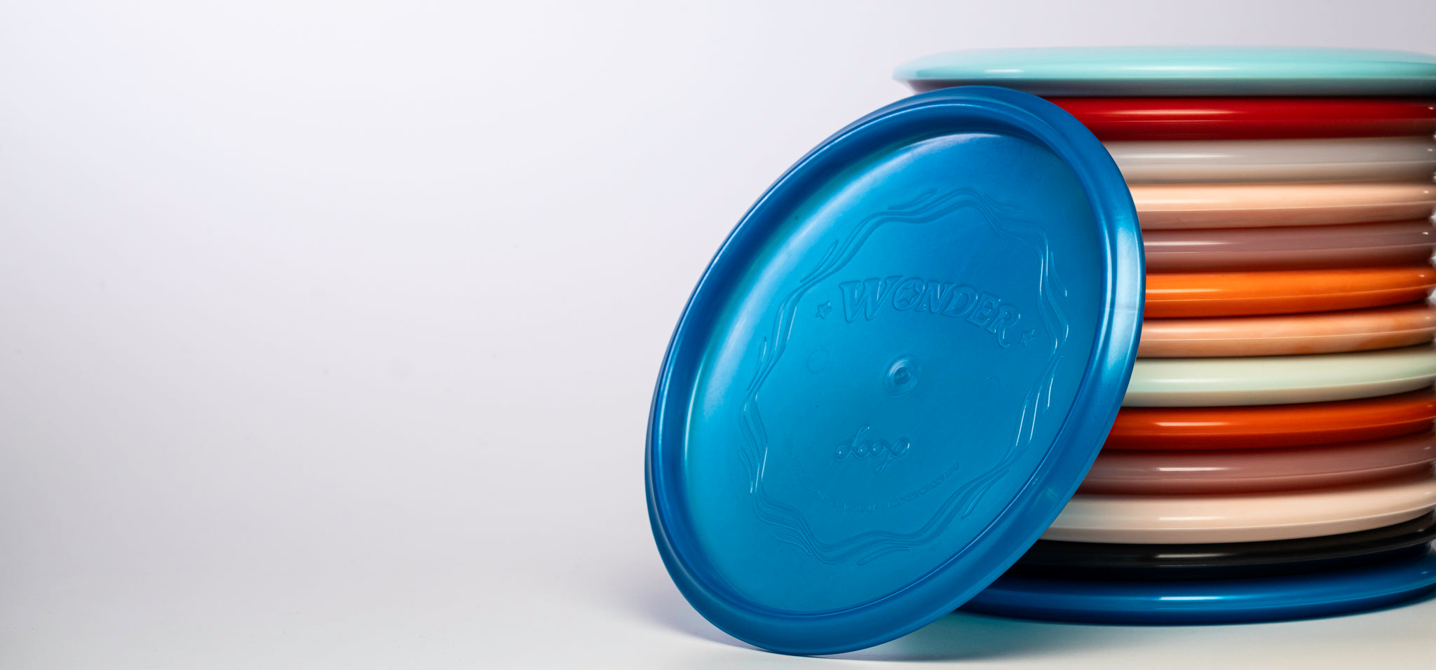 A stack of Wonder Disc Golf Discs from Loop Discs